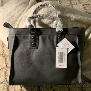 Grey purse with shoulder strap.